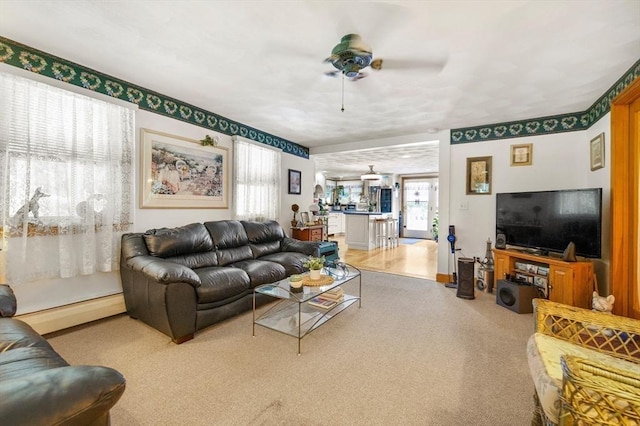 67 Main St, Atkinson, NH 03811 - carpeted living room with a baseboard heating unit and a ceiling fan