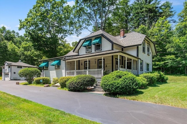 67 Main St, Atkinson, NH 03811 - view of front of property with covered porch, a front lawn, a chimney, and roof with shingles