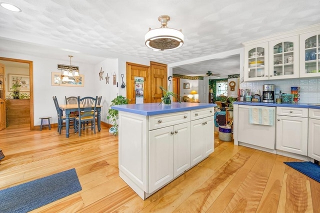 67 Main St, Atkinson, NH 03811 - kitchen featuring light wood-style flooring, white cabinetry, glass insert cabinets, and white dishwasher