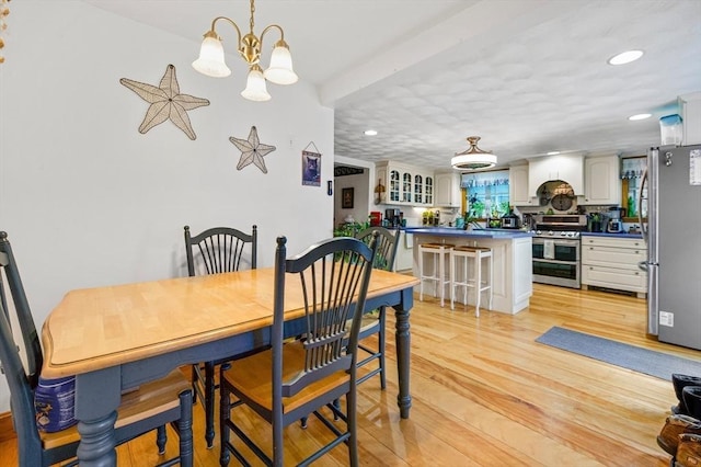 67 Main St, Atkinson, NH 03811 - dining room with a chandelier, light wood-type flooring, and recessed lighting