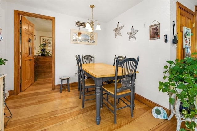 67 Main St, Atkinson, NH 03811 - dining room featuring a chandelier and light wood finished floors