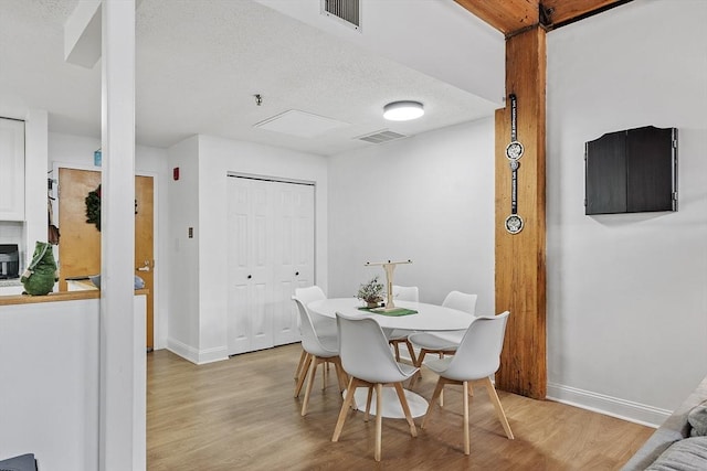 dining space with light hardwood / wood-style flooring