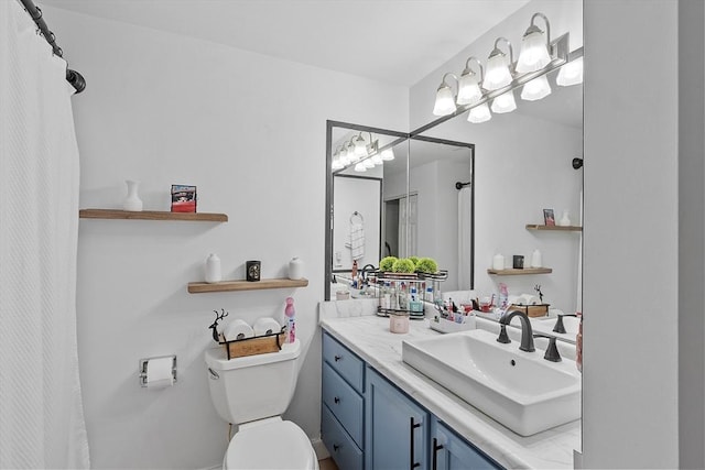 bathroom featuring toilet and vanity