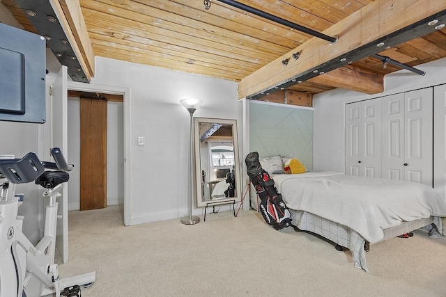 bedroom with wood ceiling, beamed ceiling, and carpet floors