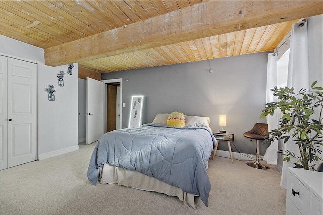 carpeted bedroom featuring beam ceiling and wood ceiling