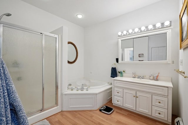 156 Langen Rd, Lancaster, MA 01523 - bathroom featuring a baseboard radiator, wood finished floors, a stall shower, vanity, and a bath