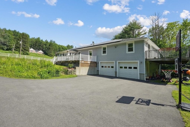 156 Langen Rd, Lancaster, MA 01523 - view of front facade with a deck, asphalt driveway, and a garage