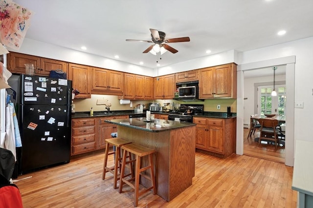 156 Langen Rd, Lancaster, MA 01523 - kitchen with black appliances, dark countertops, brown cabinets, and recessed lighting