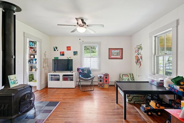 156 Langen Rd, Lancaster, MA 01523 - living area featuring a wood stove, a ceiling fan, and wood finished floors