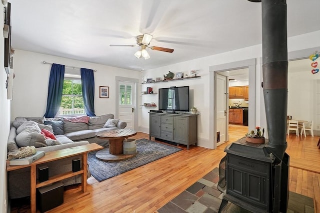 156 Langen Rd, Lancaster, MA 01523 - living area featuring a wood stove, a ceiling fan, and light wood-type flooring