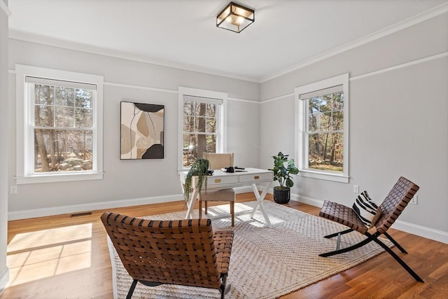 home office with visible vents, baseboards, and light wood-style flooring