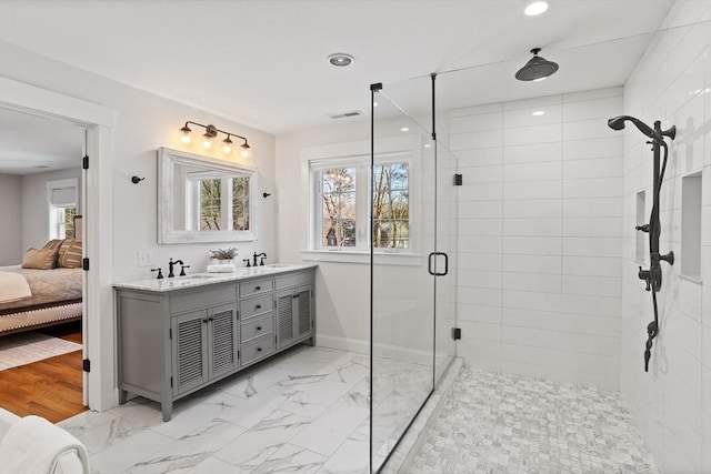 ensuite bathroom with visible vents, marble finish floor, plenty of natural light, and a shower stall