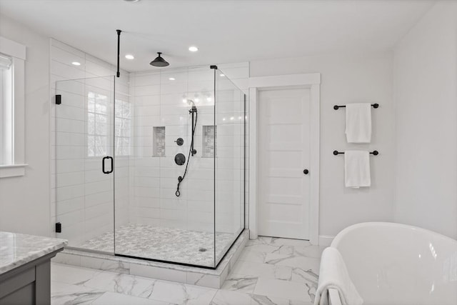 full bathroom with marble finish floor, a stall shower, recessed lighting, baseboards, and a soaking tub