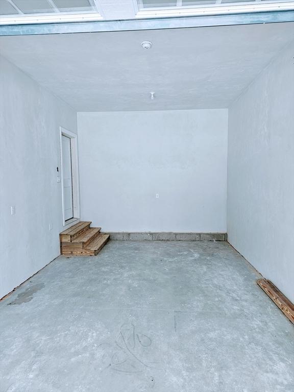 interior space featuring unfinished concrete flooring