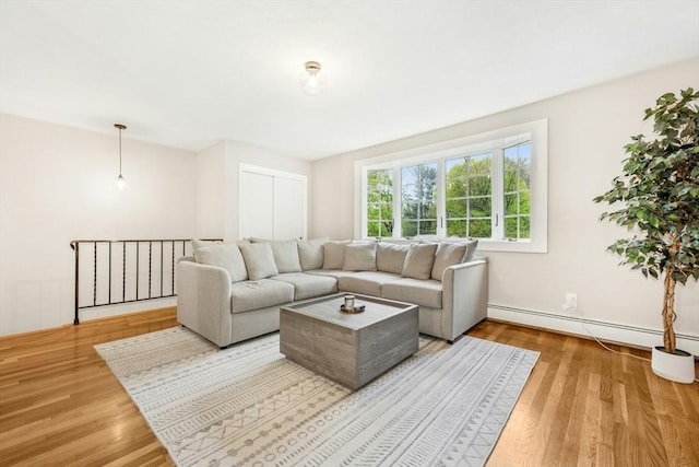 living room with wood finished floors and a baseboard radiator