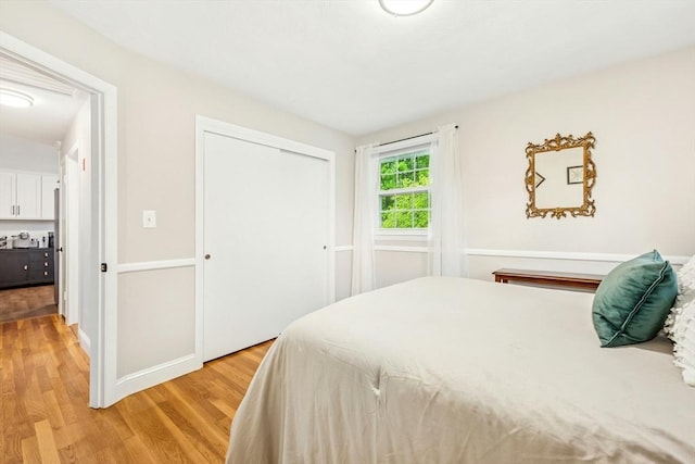 bedroom featuring a closet and light wood-type flooring