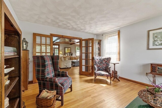 5 Vasa St, Billerica, MA 01862 - sitting room featuring french doors, light wood-style flooring, a textured ceiling, and ceiling fan