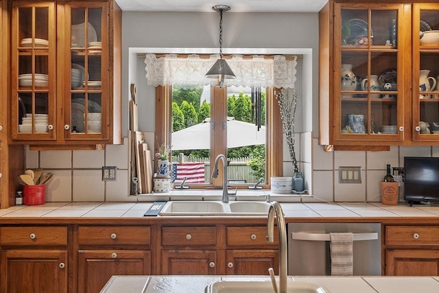 5 Vasa St, Billerica, MA 01862 - kitchen with brown cabinets, tile counters, glass insert cabinets, and backsplash