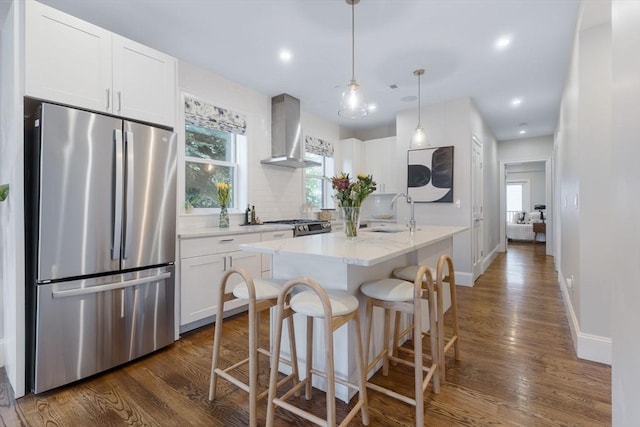 1650 Columbia Rd Unit 2, Boston, MA 02127 - kitchen with stainless steel appliances, wall chimney range hood, dark wood finished floors, backsplash, and white cabinetry