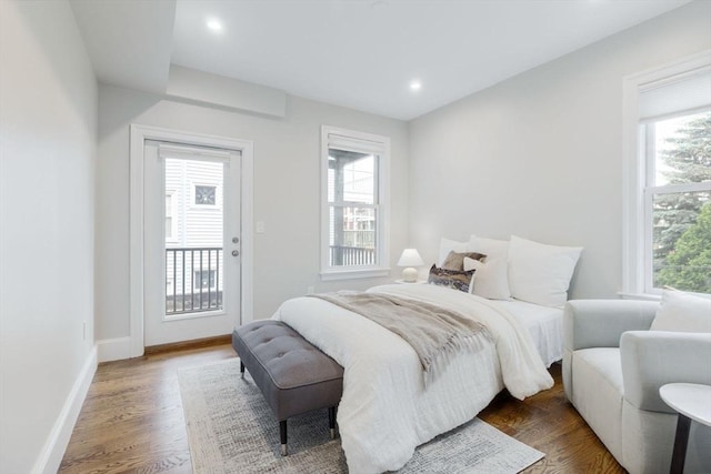 1650 Columbia Rd Unit 2, Boston, MA 02127 - bedroom with access to outside, multiple windows, wood finished floors, and recessed lighting