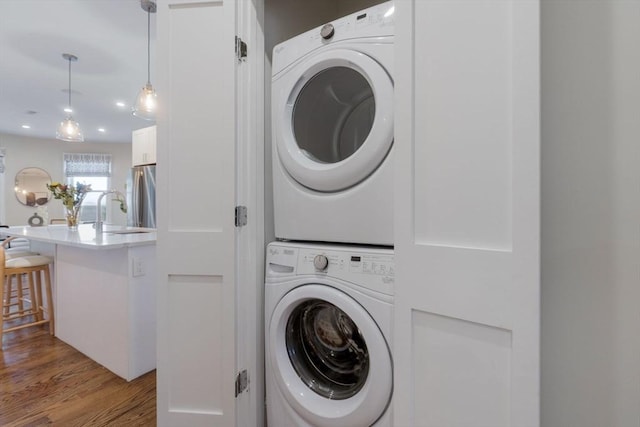 1650 Columbia Rd Unit 2, Boston, MA 02127 - laundry area with stacked washer / drying machine and wood finished floors