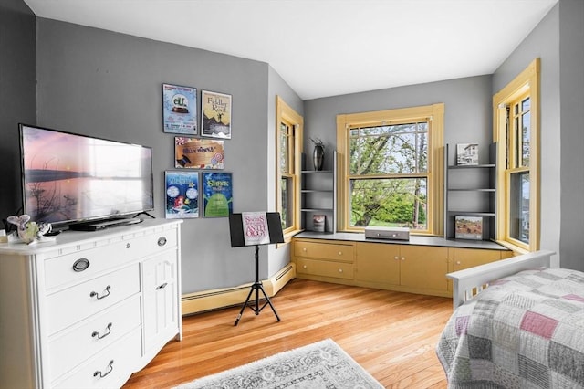 bedroom featuring a baseboard radiator and light wood-type flooring