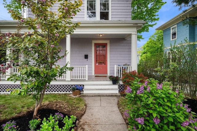 doorway to property featuring covered porch