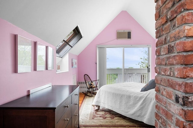 bedroom featuring lofted ceiling, access to outside, and light wood-style floors