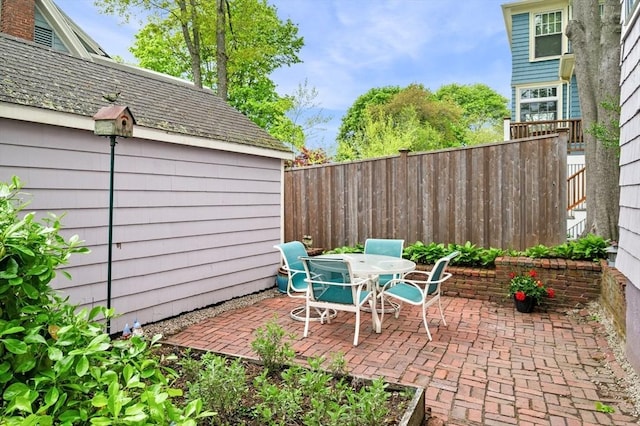 view of patio featuring a fenced backyard and outdoor dining area