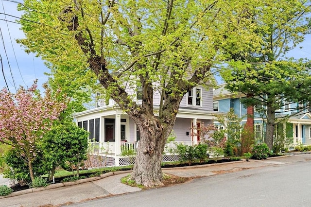 obstructed view of property with covered porch