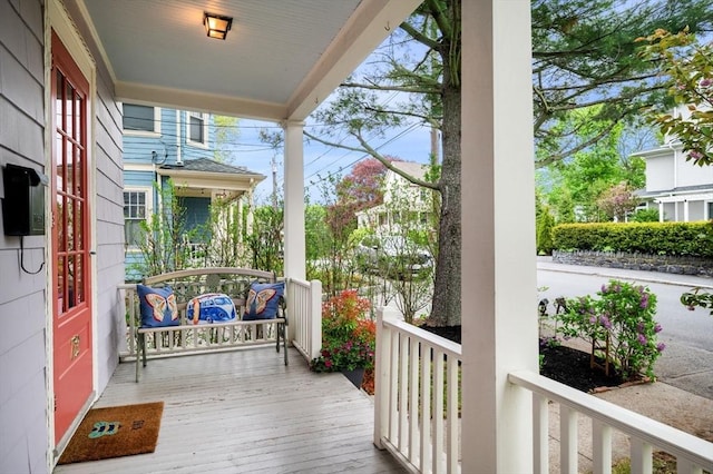 wooden terrace featuring covered porch