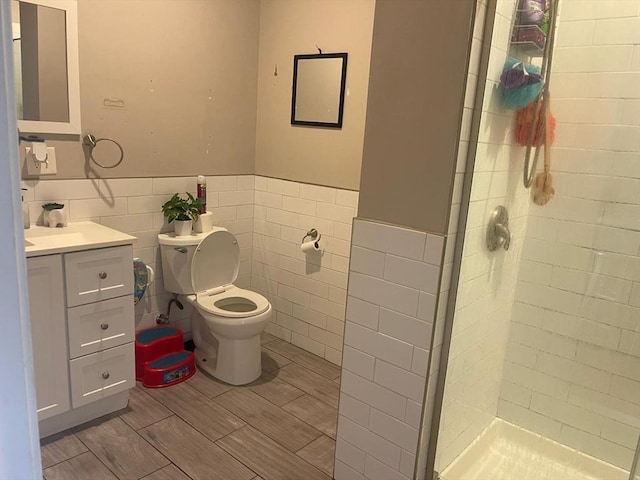 108 Grove St, Lynn, MA 01905 - full bathroom with vanity, a shower stall, tile walls, wainscoting, and wood finished floors