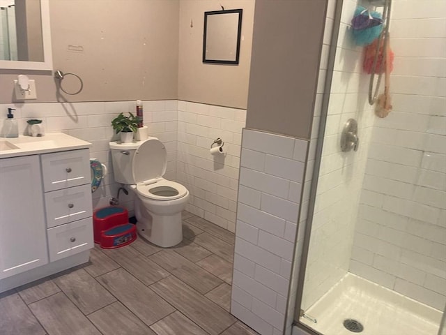 108 Grove St, Lynn, MA 01905 - bathroom with a shower stall, vanity, tile walls, and a wainscoted wall