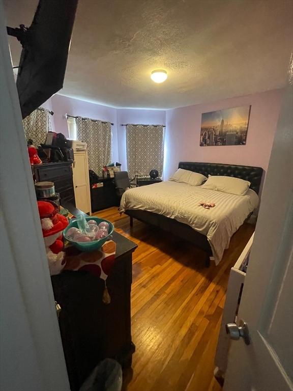 108 Grove St, Lynn, MA 01905 - bedroom featuring wood finished floors and a textured ceiling