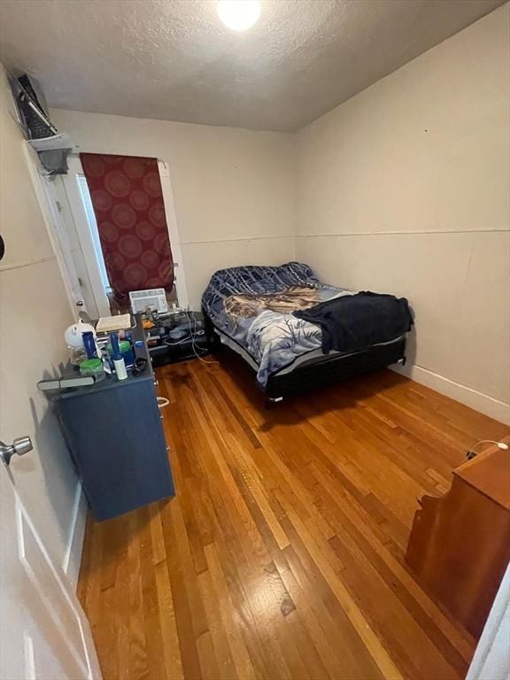 108 Grove St, Lynn, MA 01905 - bedroom featuring wood finished floors and a textured ceiling