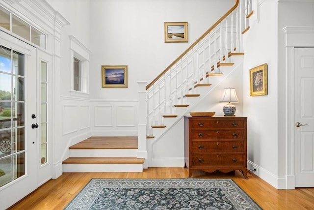 interior space featuring stairs, baseboards, and wood finished floors