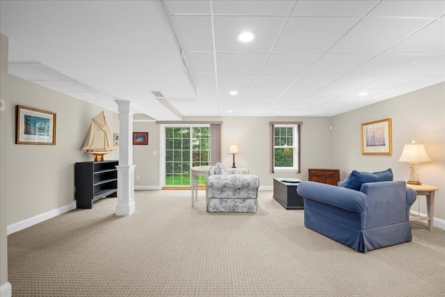 living room featuring light colored carpet, recessed lighting, baseboards, and decorative columns