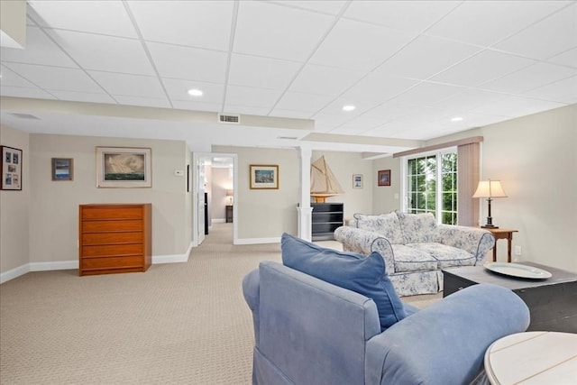 living room with light colored carpet, a drop ceiling, visible vents, and baseboards