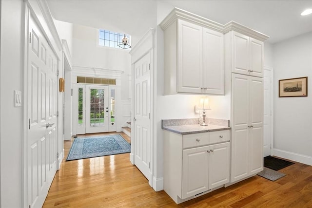 interior space with light wood-style floors, baseboards, a healthy amount of sunlight, and recessed lighting
