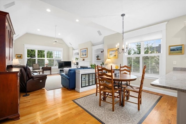 dining area featuring recessed lighting, light wood finished floors, ceiling fan with notable chandelier, and vaulted ceiling