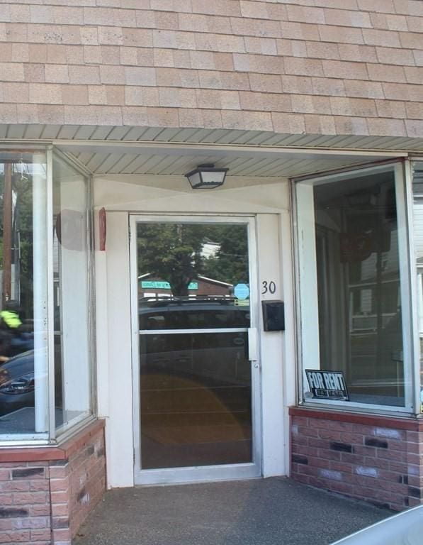 28-30 W Main St, Ware, MA 01082 - property entrance with a shingled roof