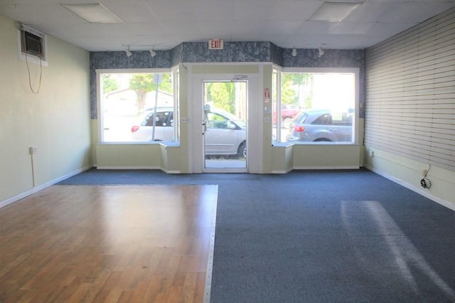 28-30 W Main St, Ware, MA 01082 - unfurnished room featuring an AC wall unit and wood finished floors