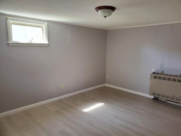 28-30 W Main St, Ware, MA 01082 - empty room with wood finished floors and heating unit