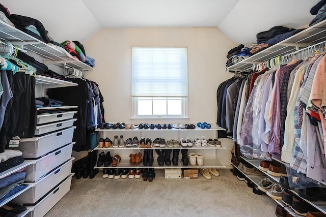 spacious closet featuring vaulted ceiling and carpet floors