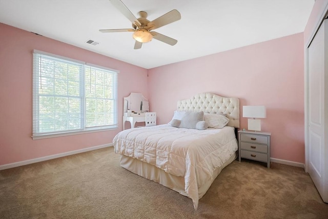 bedroom featuring carpet floors, a closet, visible vents, and baseboards