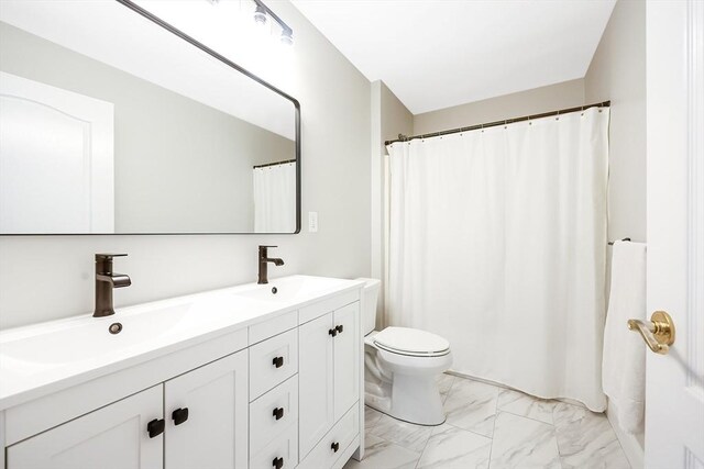 full bathroom featuring marble finish floor, a sink, toilet, and double vanity