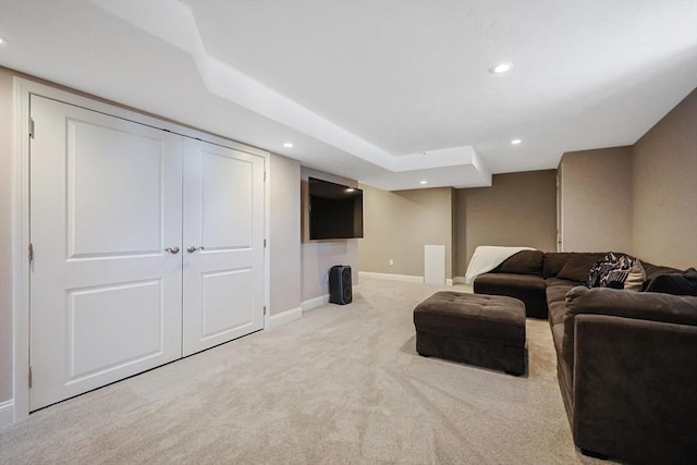 living room with recessed lighting, light colored carpet, and baseboards