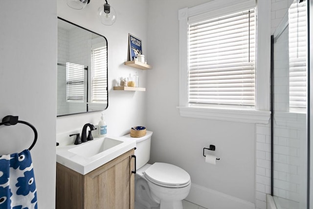 bathroom with vanity, toilet, and walk in shower