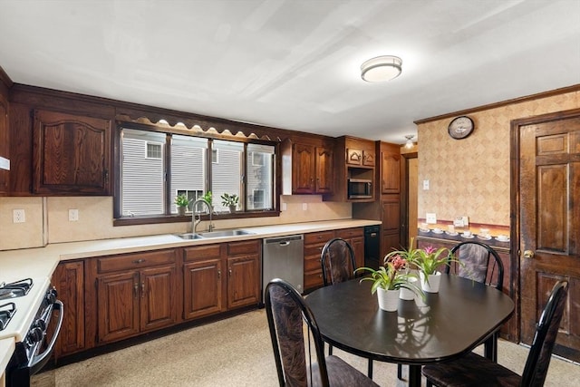 349 Pleasant St, Milton, MA 02186 - kitchen with wallpapered walls, stainless steel appliances, and light countertops