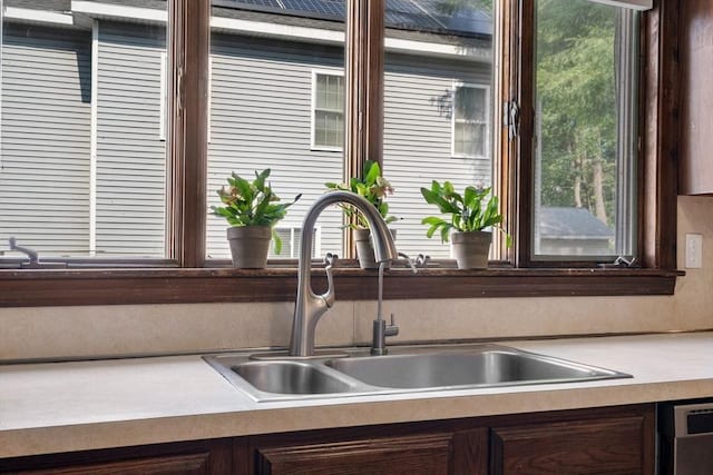 349 Pleasant St, Milton, MA 02186 - kitchen featuring dishwasher, dark brown cabinets, and light countertops